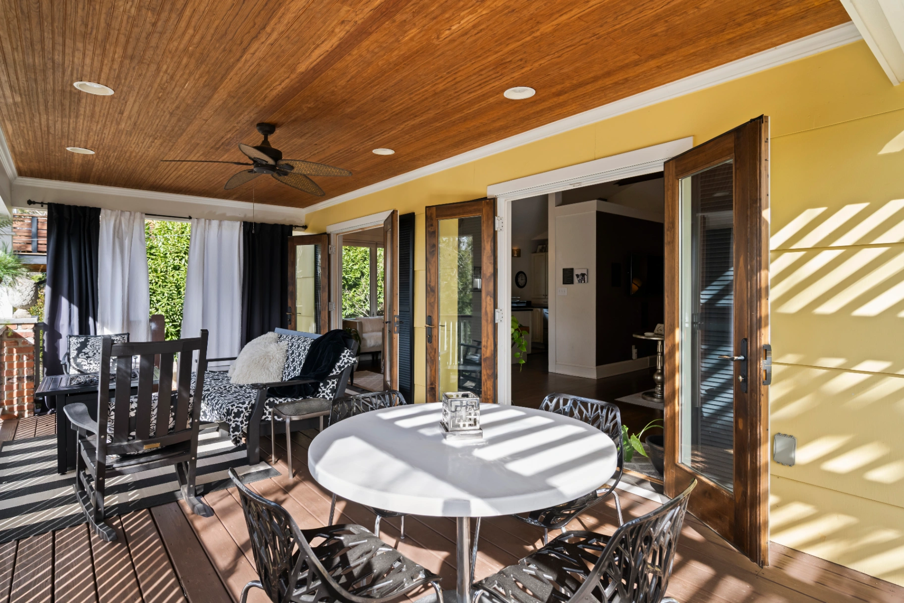 Covered deck with outdoor dining table and seating area — Asheville NC vacation rental