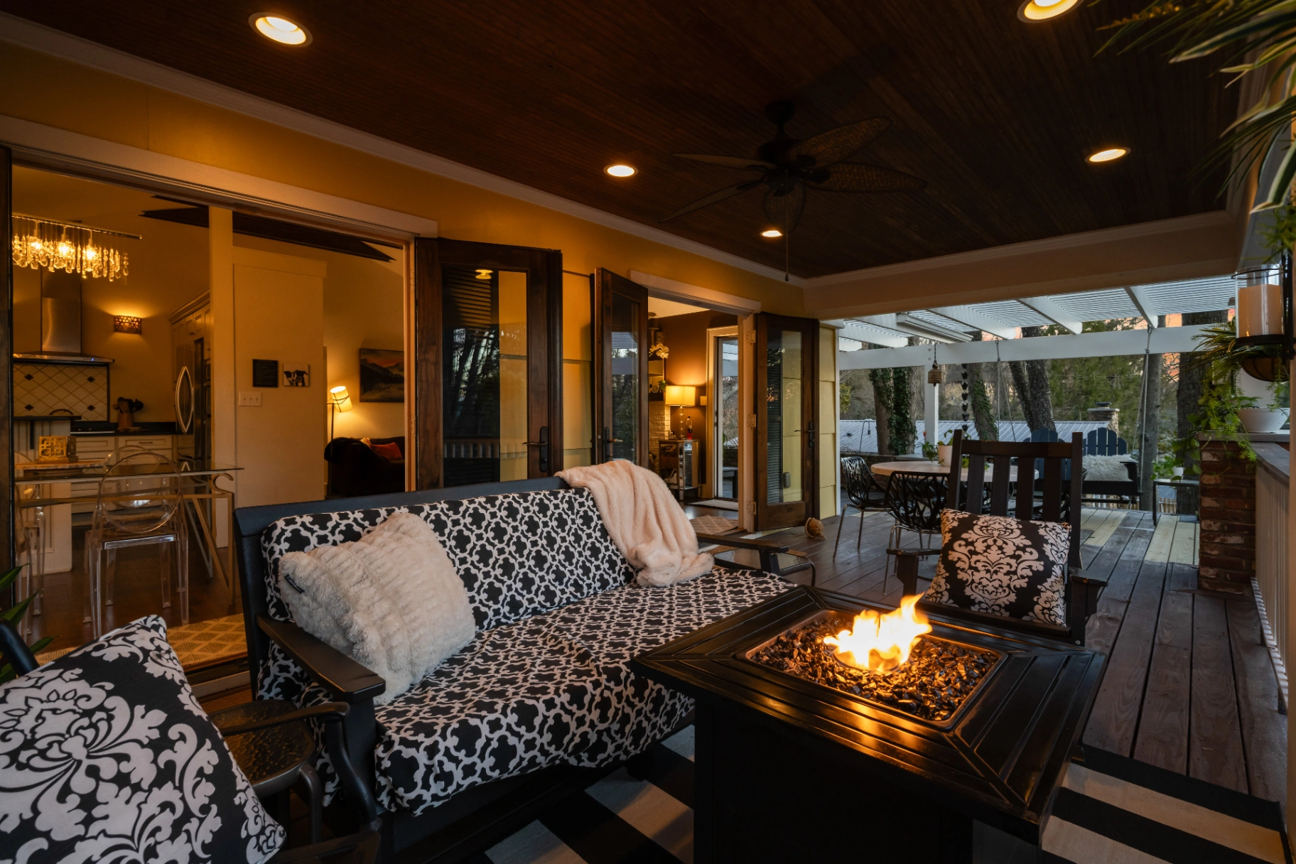 Cozy covered patio with fire pit and patterned outdoor furniture — Asheville intimate gatherings outdoor lounge