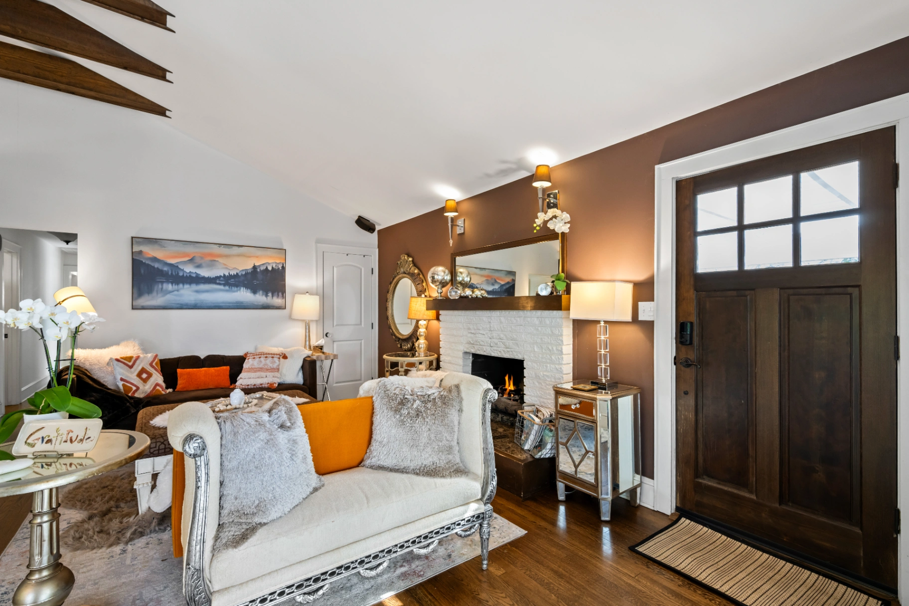 Cozy living room with fireplace and front door view — inviting entrance to Asheville vacation rental