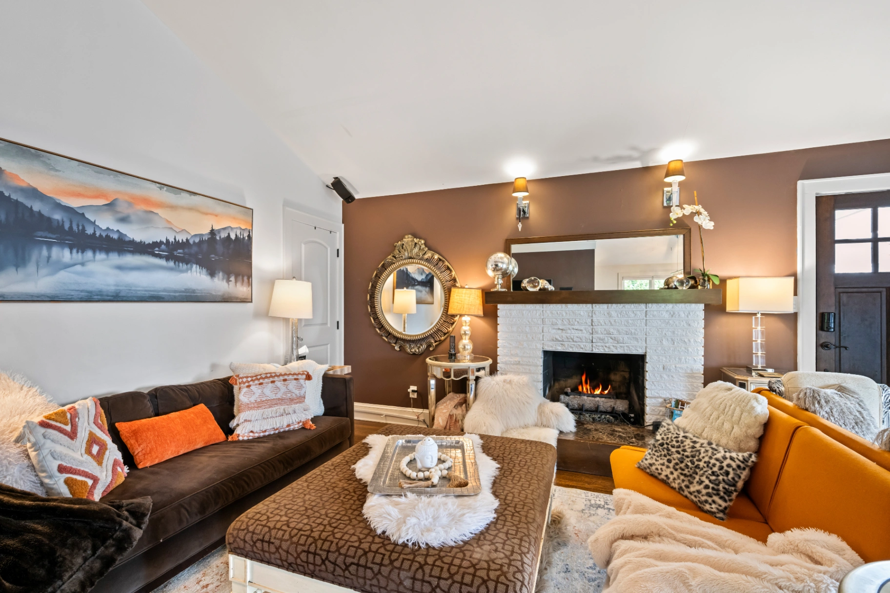 Cozy living room with white stone fireplace and eclectic decor — mid-century modern Asheville rental