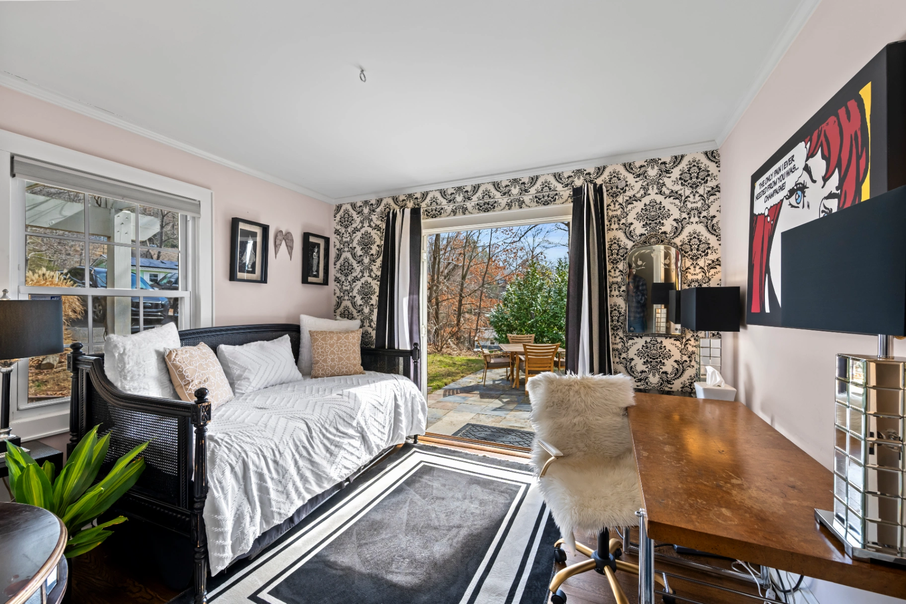 Eclectic bedroom with daybed and damask wallpaper — unique mid-century Asheville vacation rental room
