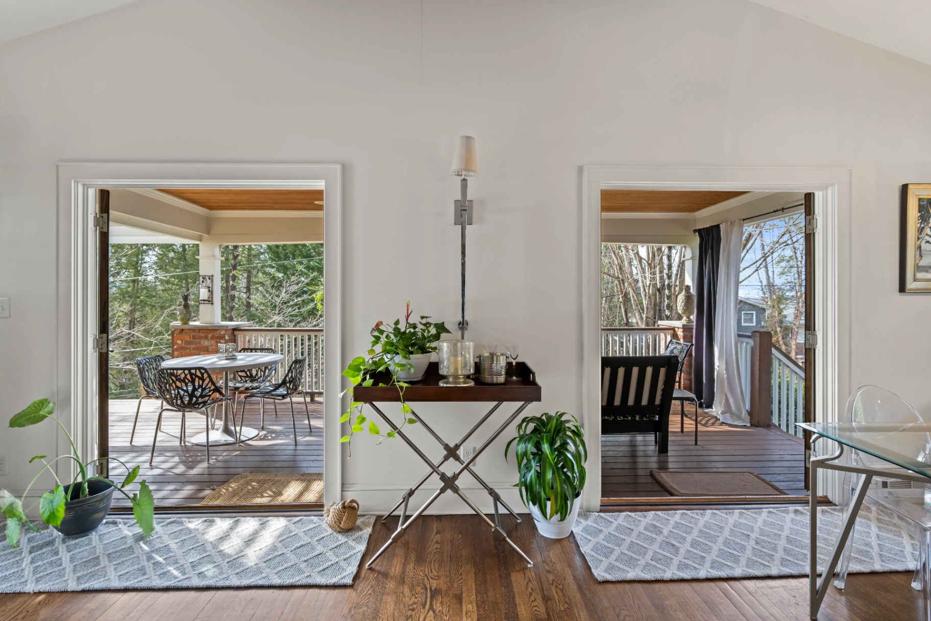 Living room leading to outdoor deck with patio furniture — indoor-outdoor flow at Asheville rental