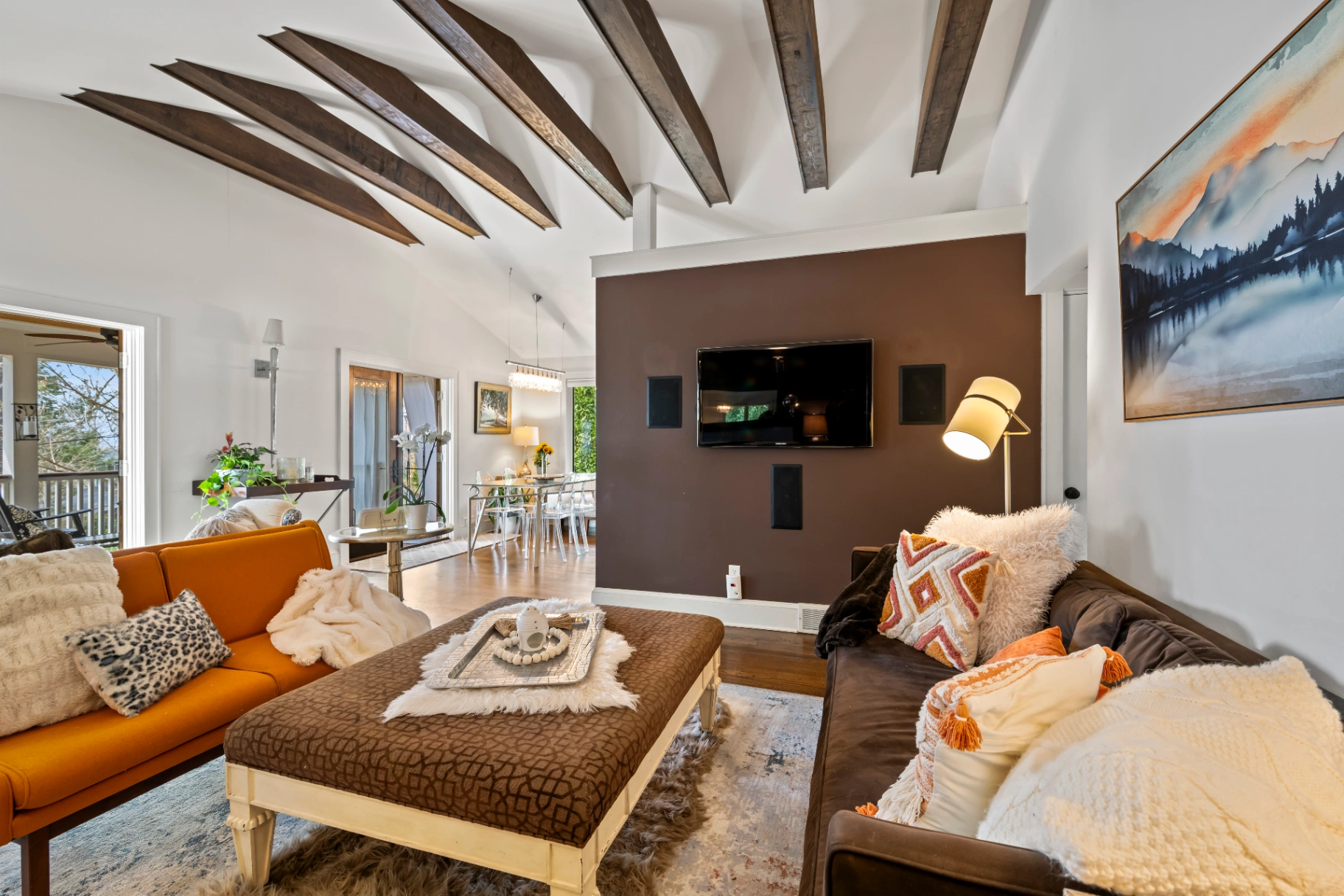 Living room with vaulted ceiling and exposed wooden beams — Asheville vacation rental spacious interior