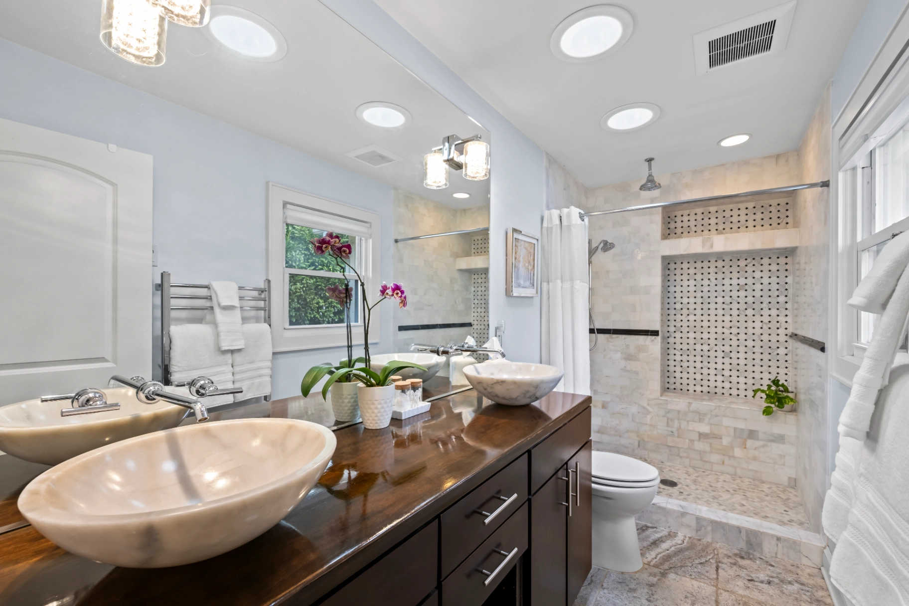Modern bathroom with double vessel sink vanity and tiled shower — Asheville NC vacation rental bathroom