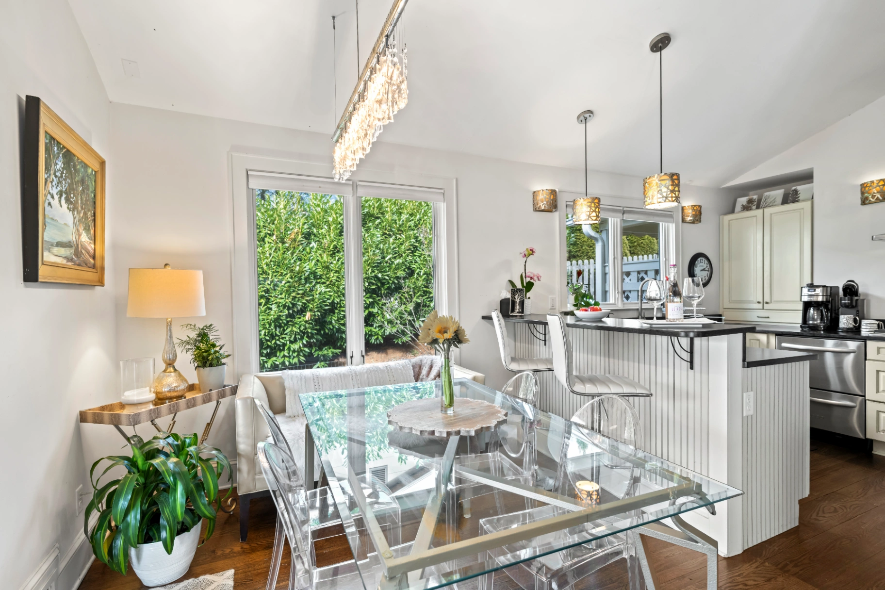 Modern dining area with glass table and kitchen island breakfast bar — Asheville NC rental dining