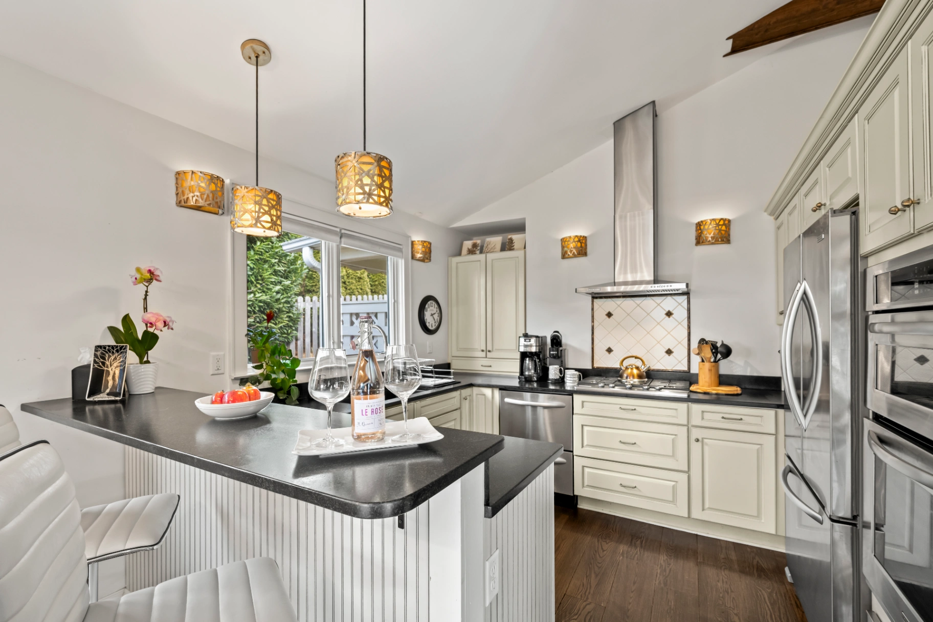 Modern kitchen with white cabinets and breakfast bar — Asheville NC vacation rental kitchen