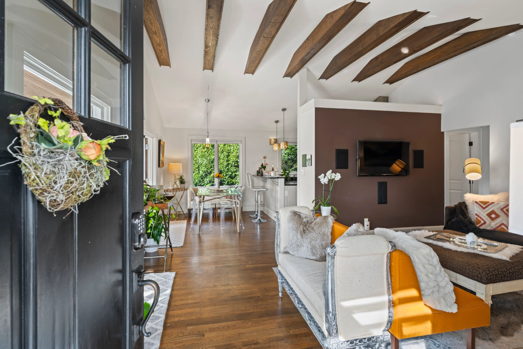 Modern open concept living room with vaulted wood beam ceilings — Asheville NC rental home