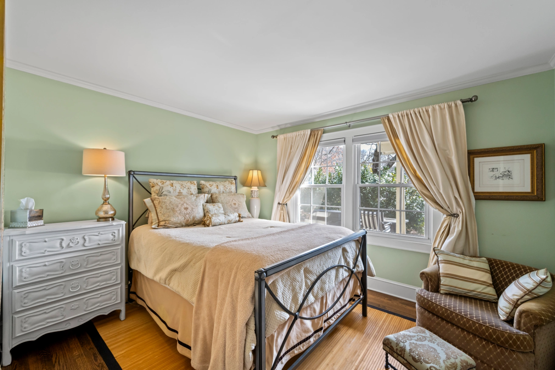 Traditional bedroom with light green walls and metal bed frame — Asheville NC vacation home bedroom